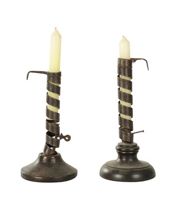 Lot 1007 - TWO 18TH CENTURY SPIRAL STEM IRONWORK PIGTAIL CANDLESTICKS