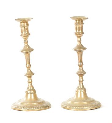 Lot 933 - A PAIR OF 18TH CENTURY BRASS SEAMED CANDLESTICKS