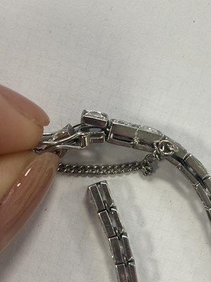 Lot 272 - A LADIES' 18CT WHITE GOLD DIAMOND TENNIS BRACELET