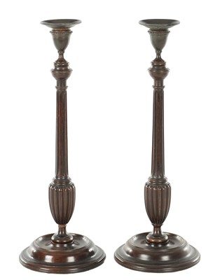 Lot 1098 - A PAIR OF GEORGIAN STYLE BRONZE AND MAHOGANY CANDLESTICKS