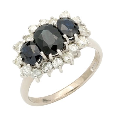Lot 403 - A WHITE GOLD SAPPHIRE AND DIAMOND DRESS RING