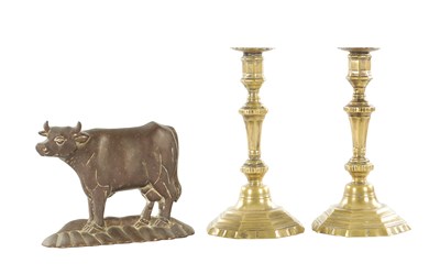 Lot 954 - A PAIR OF 18TH BRASS SEAMED CANDLESTICKS OF OCTAGONAL FORM