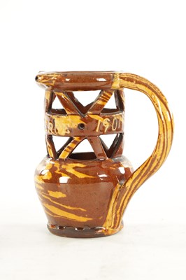 Lot 19 - AN EARLY 20TH CENTURY CLITHEROE SLIPWARE PUZZLE JUG