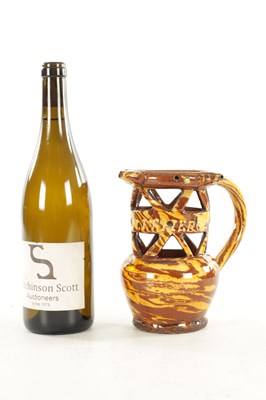 Lot 19 - AN EARLY 20TH CENTURY CLITHEROE SLIPWARE PUZZLE JUG