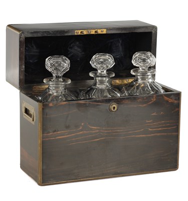 Lot 966 - A 19TH CENTURY BRASS BOUND COROMANDEL AND CUT GLASS THREE-BOTTLE DECANTER BOX