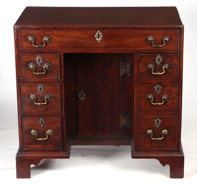 Lot 687 - AN EARLY GEORGE III MAHOGANY KNEEHOLE DESK the...