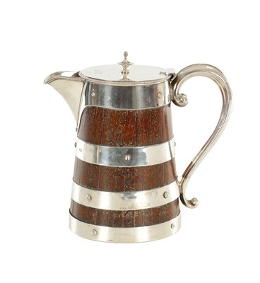 Lot 124 - A LATE 19TH CENTURY SILVER AND OAK JUG
