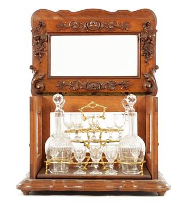 Lot 1147 - A 19TH CENTURY CARVED WALNUT FRENCH DECANTER LICQUOR CABINET