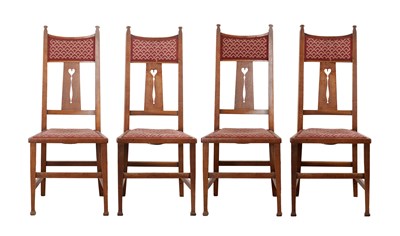 Lot 1374 - POSSIBLY BY 'ARTHUR W. SIMPSON' OF KENDAL A SET OF FOUR ARTS AND CRAFTS OAK DINING CHAIRS WITH HEART-PIERCED SPLATS