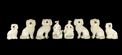 Lot 1665 - TWO PAIRS OF STAFFORDSHIRE POODLES AND A PAIR OF LATE SPANIELS