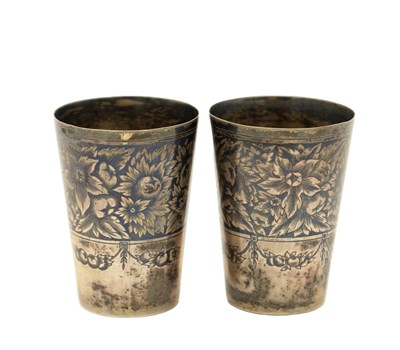 Lot 115 - A PAIR OF RUSSIAN SILVER NIELLO VODKA CUPS