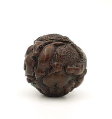 Lot 582 - A JAPANESE MEIJI PERIOD CARVED HARDWOOD NETSUKE