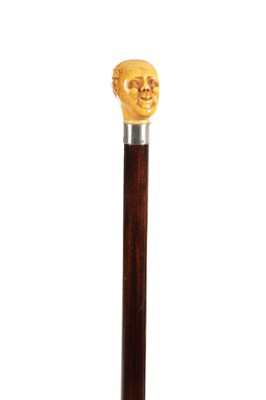 Lot 1450 - A 19TH CENTURY CARVED IVORY MAN HEAD WALKING CANE