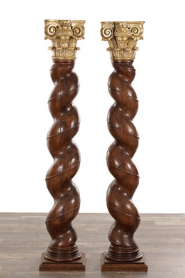 Lot 1555 - A PAIR OF EARLY 18TH CENTURY WALNUT BARLEY TWIST COLUMNS WITH GILT CORINTHIAN CAPITALS ON SQUARE PLINTH BASES