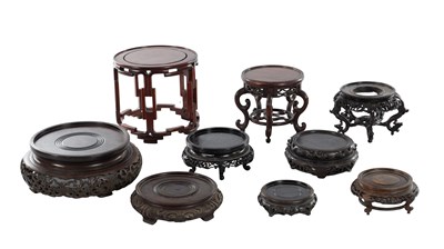 Lot 396 - A COLLECTION OF NINE CHINESE CARVED HARDWOOD STANDS
