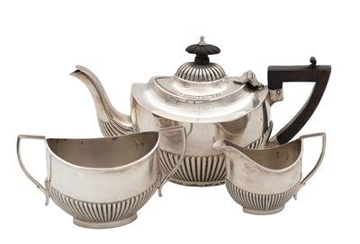 Lot 153 - AN EARLY 20TH CENTURY SILVER THREE-PIECE TEA SERVICE