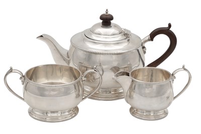 Lot 108 - AN EARLY 20TH CENTURY SILVER THREE-PIECE TEA SERVICE