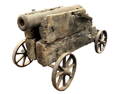 Lot 620 - AN EARLY CAST IRON CANNON ON ITS ORIGINAL OAK-FRAMED CARRIAGE
