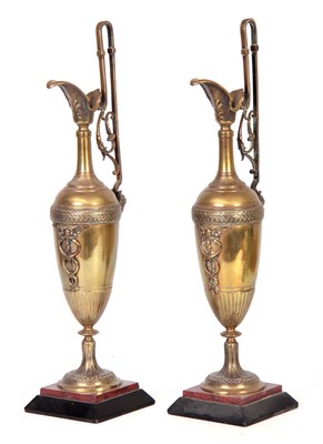 Lot 1037 - A PAIR OF LATE 19TH CENTURY BRONZE EWERS ON SLATE AND ROUGE MARBLE BASES