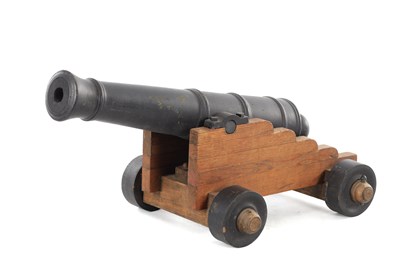 Lot 638 - A 20TH CENTURY WOODEN MODEL CANNON ON A CARRIAGE