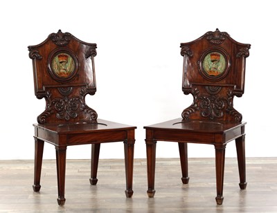 Lot 1398 - A PAIR OF 20TH CENTURY MAHOGANY CHIPPENDALE STYLE HALL CHAIRS WITH ARMORIAL PAINTED ROUNDELS