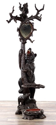 Lot 831 - A 19TH CENTURY BLACK FOREST CARVED LINDEN WOOD BEAR HALL STAND WITH HEART-SHAPED MIRROR