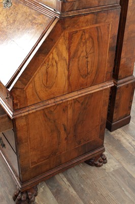 Lot 1539 - A GEORGE I BURR WALNUT BUREAU BOOKCASE WITH BROKEN ARCH PEDIMENT AND MIRRORED DOORS