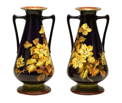 Lot 62 - A PAIR OF EARLY 20TH CENTURY DOULTON LAMBETH TWIN HANDLED CERAMIC TAPERING VASES