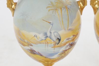 Lot 55 - A FINE PAIR OF EARLY 20TH CENTURY ROYAL WORCESTER PORCELAIN TWIN-HANDLED CABINET VASES BY JOHNSON