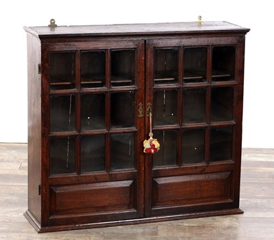 Lot 1507 - A GEORGE II OAK HANGING GLAZED CUPBOARD