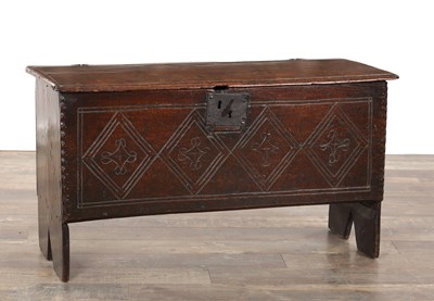 Lot 1498 - A 17TH CENTURY ENGLISH OAK SIX-PLANK COFFER WITH CARVED LOZENGE FRONT