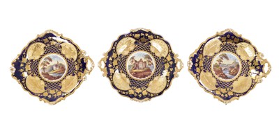Lot 51 - A SET OF THREE 19TH CENTURY ENGLISH COBALT BLUE RIDGWAY PORCELAIN TWO-HANDLED DESSERT DISHES WITH GILT AND LANDSCAPE RESERVES