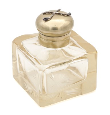 Lot 565 - A VICTORIAN CUT GLASS INKWELL WITH DOMED METAL COVER APPLIED WITH CROSSED GOLF CLUBS