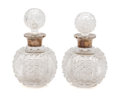 Lot 2 - A PAIR OF LATE VICTORIAN ENGLISH SILVER-MOUNTED CUT GLASS SCENT BOTTLES