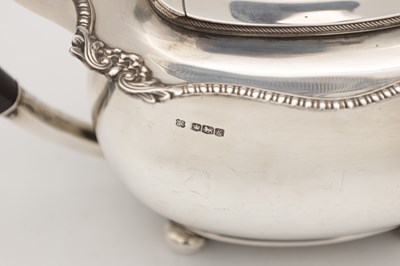 Lot 71 - AN EARLY 20TH CENTURY ENGLISH SILVER TEAPOT WITH EBONY HANDLE AND FINIAL