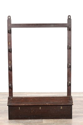 Lot 1531 - A 19TH CENTURY ESTATE STAINED PINE SHOTGUN RACK WITH PAINTED NUMBERS AND LIDDED BOX BASE