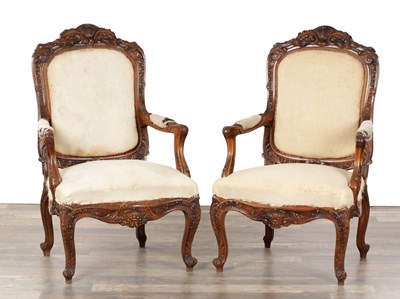 Lot 1403 - A PAIR OF 19TH CENTURY STYLE UPHOLSTERED CARVED WALNUT OPEN ARMCHAIRS