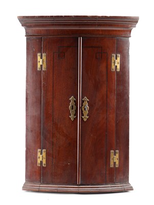 Lot 1514 - A SMALL GEORGE III MAHOGANY BOW FRONTED CORNER CUPBOARD