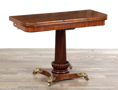 Lot 1375 - A REGENCY FIGURED MAHOGANY FOLD-OVER TEA TABLE ON A REEDED PEDESTAL BASE