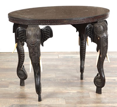 Lot 565 - A 19TH CENTURY ANGLO-INDIAN CARVED ROSEWOOD OCCASIONAL TABLE WITH ELEPHANT MASK LEGS