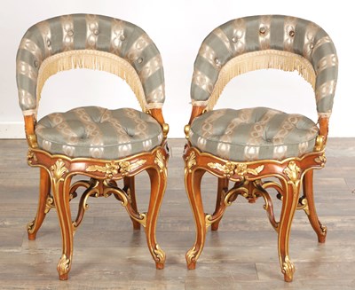 Lot 1481 - A PAIR OF 19TH CENTURY STYLE FRENCH WALNUT AND PARCEL GILT UPHOLSTERED DRESSING TABLE CHAIRS