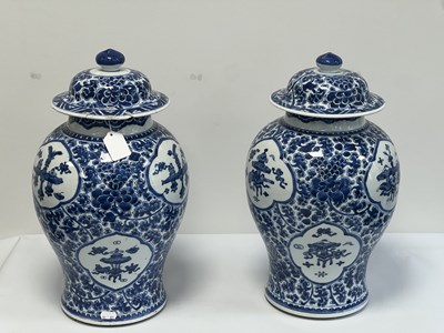 Lot 522 - A PAIR OF KANGXI PERIOD CHINESE BLUE AND WHITE BALUSTER VASES AND COVERS