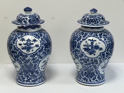 Lot 522 - A PAIR OF KANGXI PERIOD CHINESE BLUE AND WHITE BALUSTER VASES AND COVERS