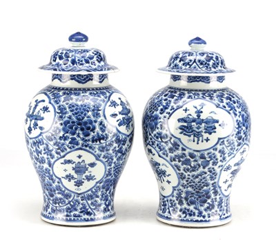 Lot 522 - A PAIR OF KANGXI PERIOD CHINESE BLUE AND WHITE BALUSTER VASES AND COVERS