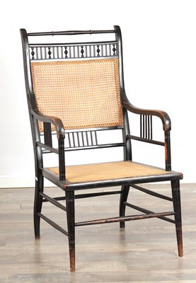 Lot 1509 - ATTRIBUTED TO E. W. GODWIN A LATE 19TH CENTURY ENGLISH EBONISED AND CANED ARMCHAIR