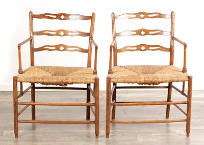 Lot 1393 - A PAIR OF 19TH CENTURY ENGLISH LADDERBACK ARMCHAIRS WITH RUSH SEATS