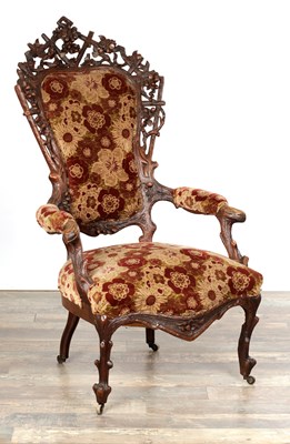 Lot 1366 - A 19TH CENTURY BLACK FOREST CARVED WALNUT UPHOLSTERED ARMCHAIR