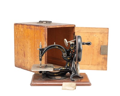 Lot 1026 - A LATE 19TH CENTURY WILCOX AND GIBBS CAST IRON SEWING MACHINE