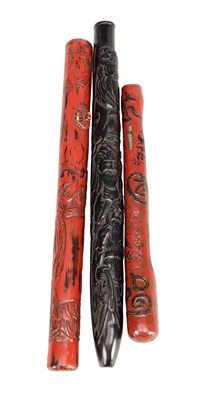 Lot 553 - THREE 19TH CENTURY JAPANESE LACQUERED AND CARVED WOOD PIPE CASES