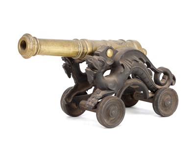 Lot 632 - A 19TH CENTURY BRASS MODEL OF A SIGNAL CANNON ON CAST IRON DRAGON CARRIAGE